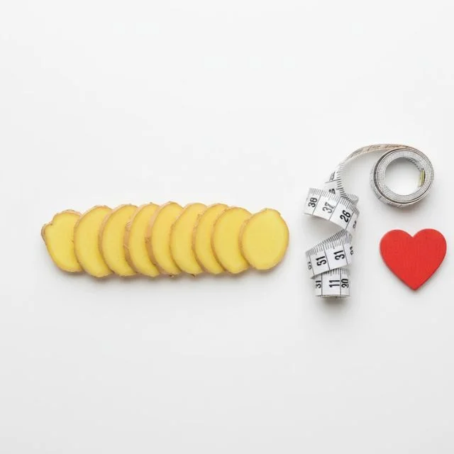 Ginger for weight loss and heart disease prevention, showing ginger slices and a measuring tape.
