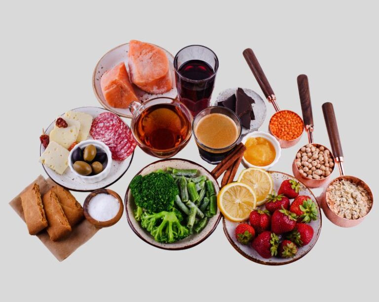 Plate of grilled salmon or mackerel with vegetables and lemon slices, rich in heart-healthy fats for blood pressure support